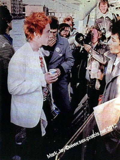 Mark Jay (far right) talks to Johnny Rotten while the cameras roll.